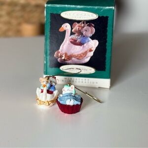 Two miniature Hallmark-style Christmas ornaments.